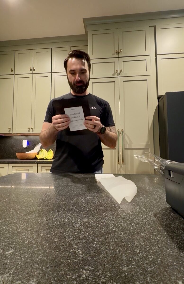 Blake holding the first labeled bag of McNeil Mixes